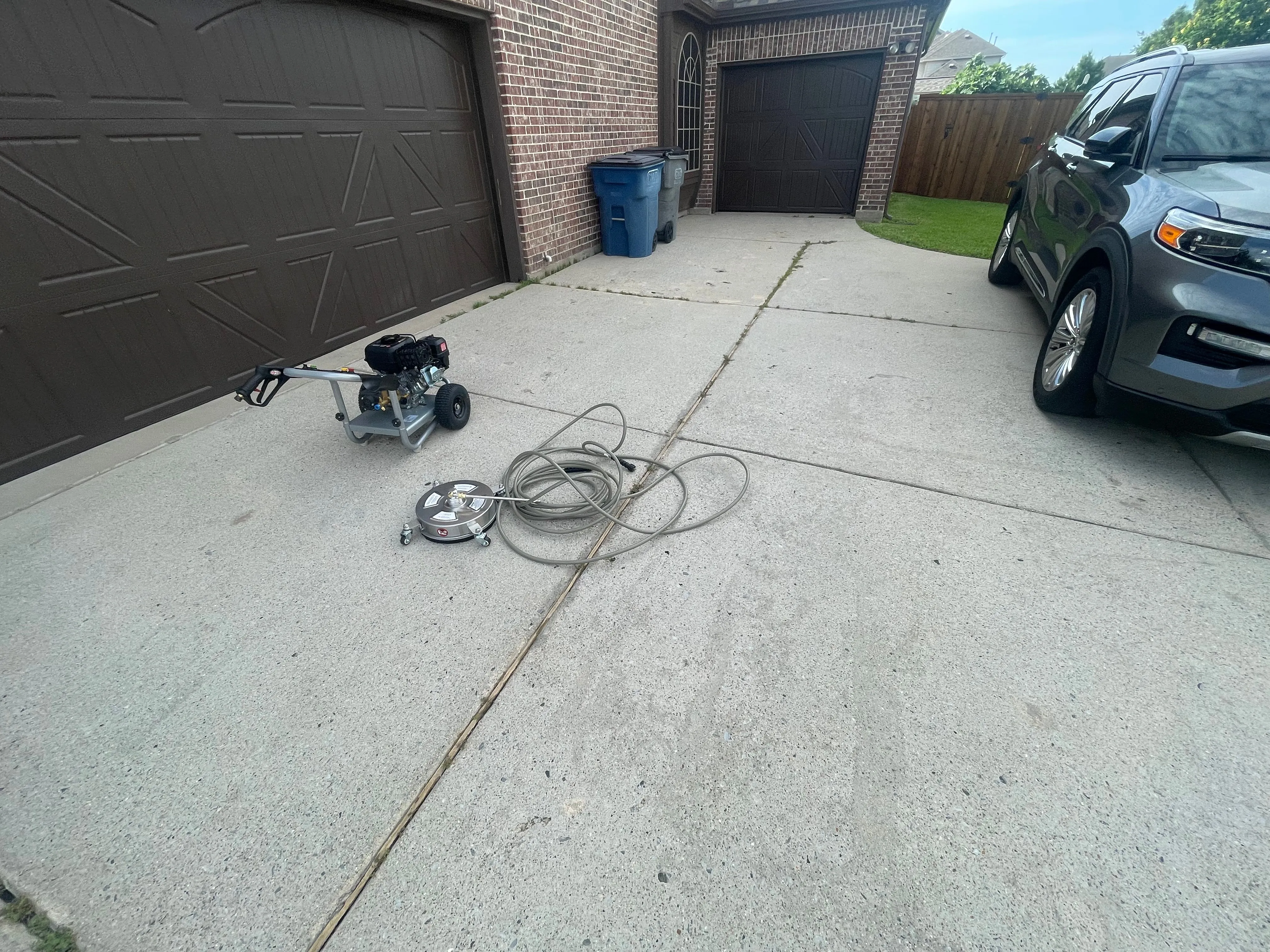 Freshly power-washed driveway in Wylie, TX with Revival Co. equipment