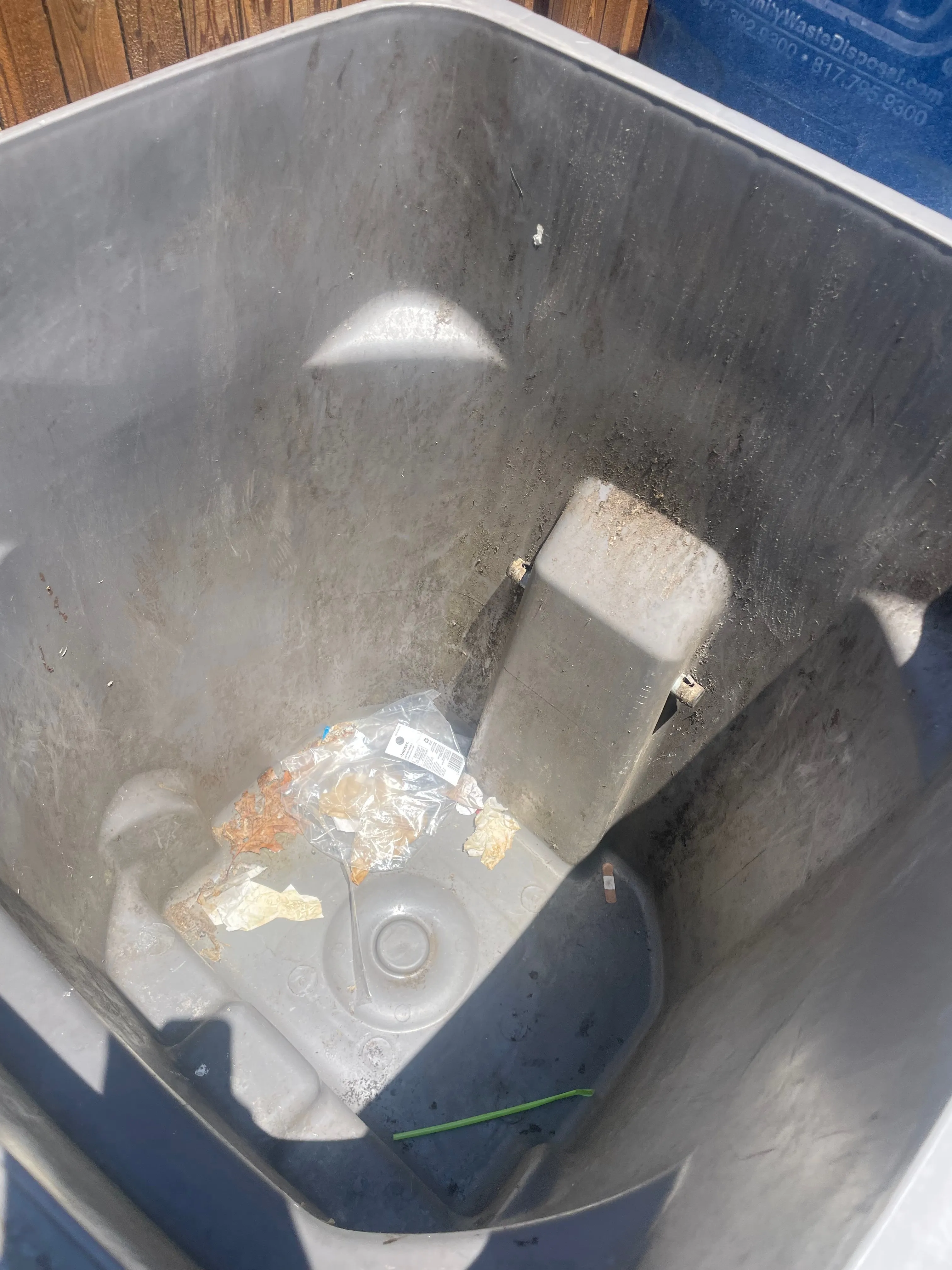 Dirty grey trash can with debris and grime inside before cleaning and sanitizing in the Dallas area